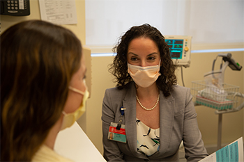 Dr Spiel consulting with masked patient