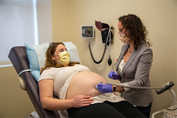 Dr Spiel performs an ultrasound on pregnant patient