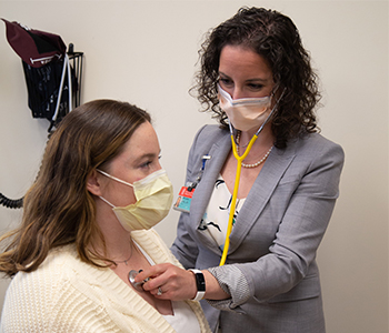 BIDMC obstetrician listening to patient with stethoscope 