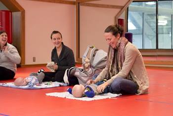 Parents and newborns attending The Parent Connection's New Parents Group. Photo taken PRE-COVID.