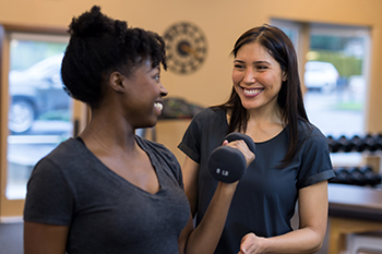 Physical Therapist with Sports Medicine Patient - Photo taken pre-COVID Physical Therapist with Sports Medicine Patient - Photo taken pre-COVID
