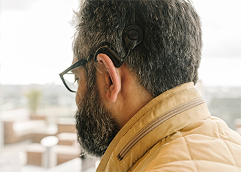 Man wears a cochlear implant on his ear