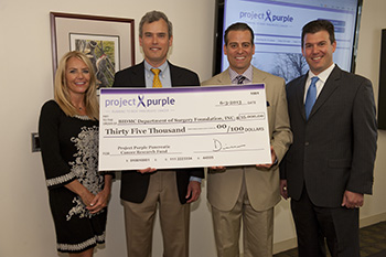 Project Purple presents BIDMC's Dr. James Moser with a check for pancreatic cancer research