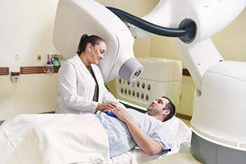 A patient prepares for CyberKnife radiation therapy.