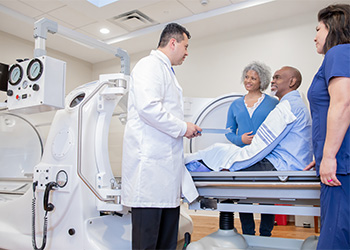 Patient listens to providers before an MRI scan