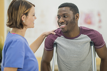 A physical therapist consults with a patient recovering from orthopedic surgery