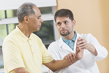 An orthopedist examines a patient's hand