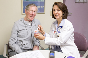 BIDMC Speech-Language Pathologist Cynthia Wagner helping a patient with a swallowing disorder.