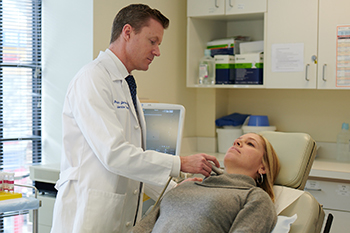 Ben James, MD, performs a pre-surgery ultrasound on a patient with hyperparathyroidism.