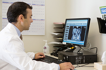 Dr. Wagner takes a closer look a patient's x-rays. Andrew A. Wagner, MD reviews a BIDMC patient's x-rays.