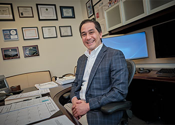 Dr. Barouch sitting at his desk Dr. Barouch sitting at his desk