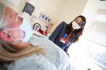 A BIDMC OB/GYN is attending to a female patient.