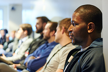 Emergency Medicine residents participate in grand rounds. 