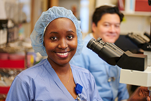 A female hospital worker in the lab with a male coworker