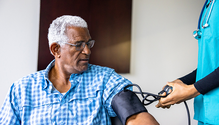 Older black man getting his blood pressure checked