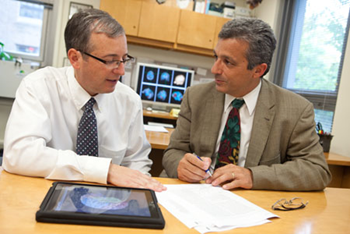 BIDMC's Dr. Pascual-Leone speaking with a man BIDMC's Dr. Pascual-Leone speaking with a man