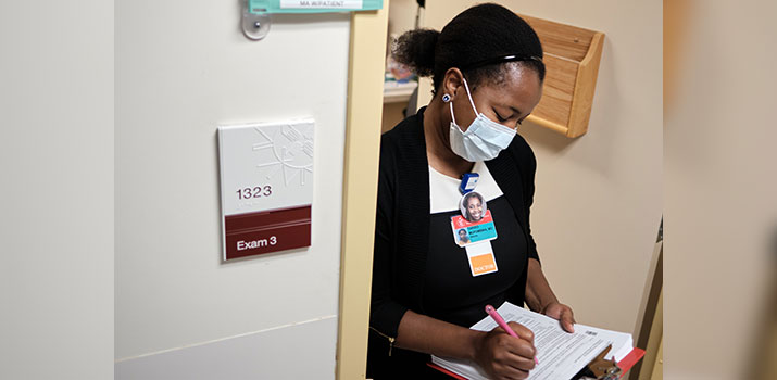 Doctor prepares forms at BIDMC Bowdoin Street Health Center
