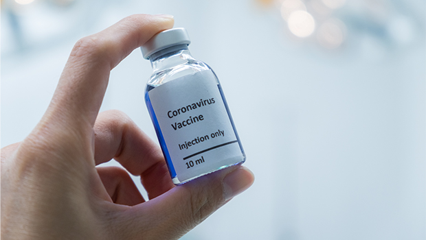 Hand holding a vial of the coronavirus vaccine