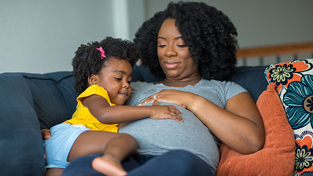 Pregnant woman with young daughter