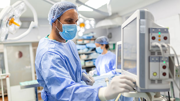 Masked male doctor in surgery